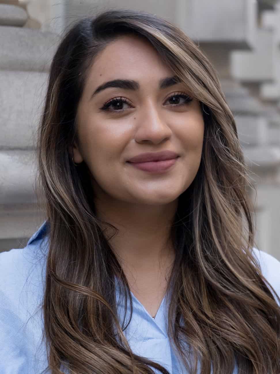 Dr Yalda smiling, wearing a blue shirt