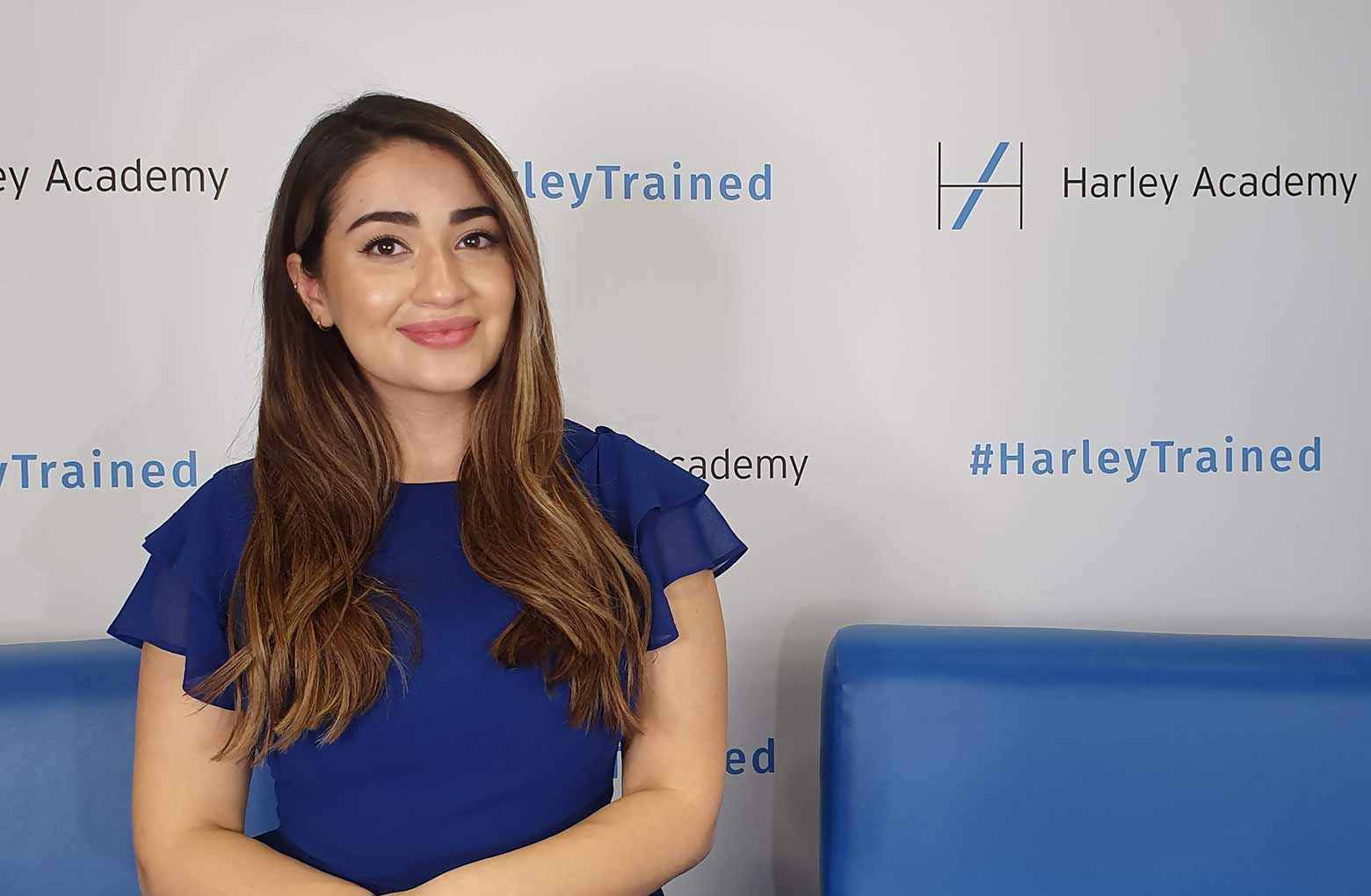 Dr Yalda in a blue dress, sitting on a blue sofa, being filmed at the CCR Expo conference